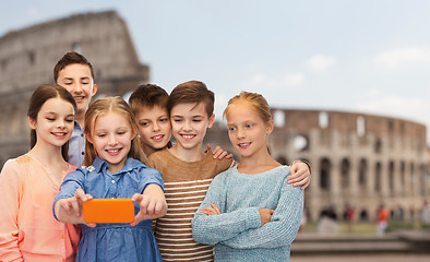 Image showing children talking smartphone selfie over coliseum