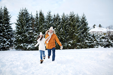 Image showing happy couple running in winter snow