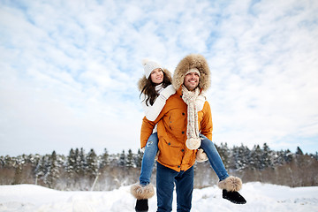 Image showing happy couple having fun over winter background