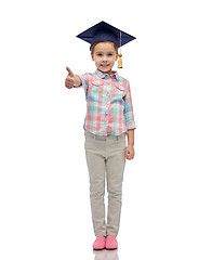 Image showing happy girl in bachelor hat showing thumbs up