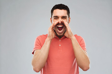 Image showing angry shouting man in t-shirt over gray background