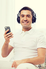 Image showing happy man with smartphone and headphones