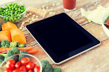 Image showing close up of blank tablet pc screen and vegetables