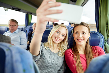 Image showing women taking selfie by smartphone in travel bus