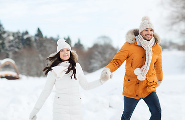 Image showing happy couple walking over winter background