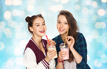 Image showing happy pretty teenage girls drinking milk shakes