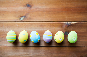 Image showing close up of colored easter eggs on wooden surface