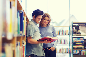 Image showing happy student couple with books in library