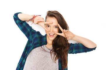 Image showing happy smiling teenage girl showing peace sign