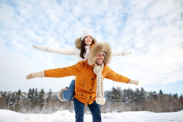 Image showing happy couple having fun over winter background