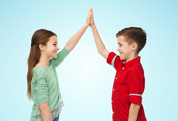 Image showing happy boy and girl making high five