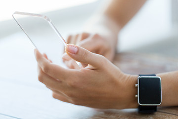 Image showing close up of hands with smart phone and watch