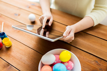 Image showing close up of woman with tablet pc and easter eggs