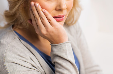 Image showing close up of woman suffering toothache at home