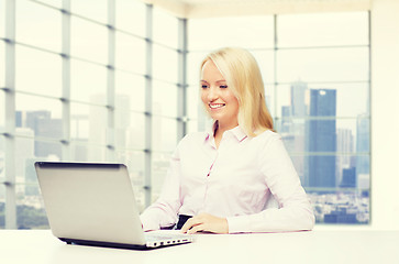 Image showing smiling businesswoman or student with laptop