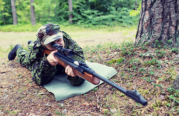 Image showing young soldier or hunter with gun in forest