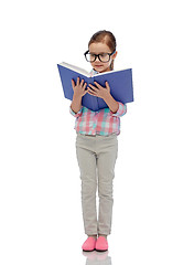 Image showing happy little girl in eyeglasses reading book