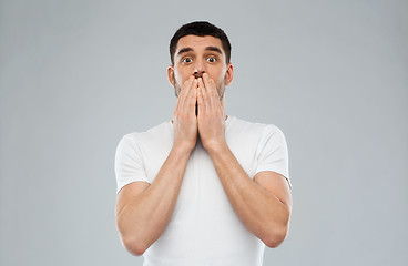 Image showing scared man in white t-shirt over gray background