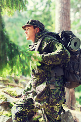 Image showing young soldier with backpack in forest