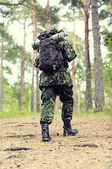 Image showing young soldier with backpack in forest