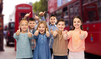 Image showing happy children showing thumbs up over london city