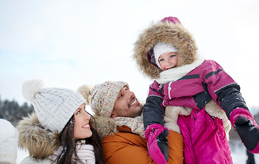 Image showing happy family with child in winter clothes outdoors