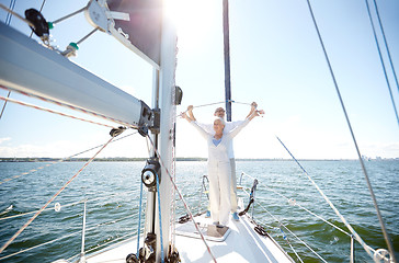 Image showing senior couple hugging on sail boat or yacht in sea