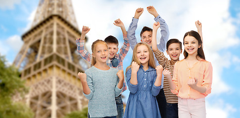 Image showing happy kids celebrating victory over eiffel tower