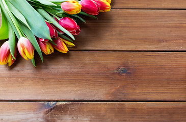 Image showing close up of tulip flowers on wooden table