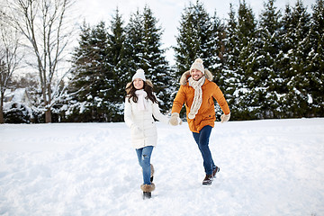 Image showing happy couple running in winter snow