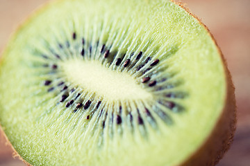 Image showing close up of ripe kiwi slice on table