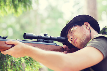 Image showing young soldier or hunter with gun in forest