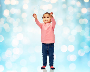 Image showing little baby girl playing with soap bubble