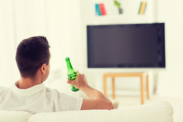 Image showing man watching tv and drinking beer at home