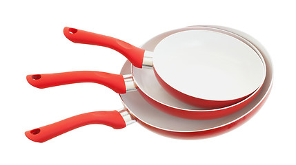 Image showing Set of three frying pans, red