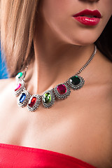 Image showing necklace on the neck. ruby and emerald