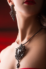 Image showing necklace on female neck. girl holding hands. sexy red lips.