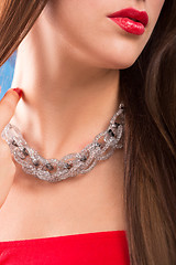 Image showing necklace on female neck. girl holding hands. sexy red lips.