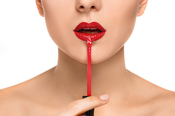 Image showing Beautiful female lips with make-up and brush