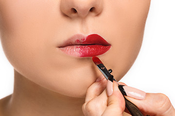 Image showing Beautiful female lips with make-up and brush