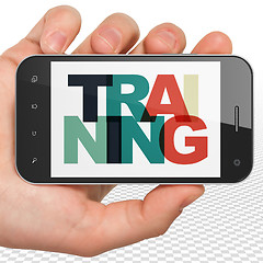 Image showing Studying concept: Hand Holding Smartphone with Training on  display