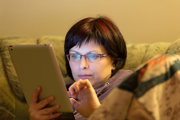 Image showing woman reading news on tablet