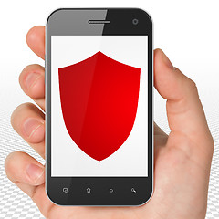 Image showing Security concept: Hand Holding Smartphone with Shield on display
