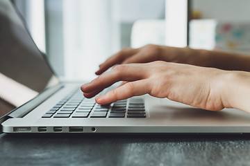 Image showing woman\'s hands working on laptop computer