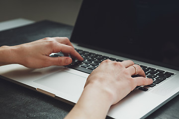 Image showing woman\'s hands working on laptop computer