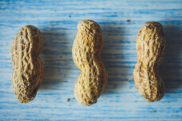 Image showing Fresh peanuts in shell on blue desk