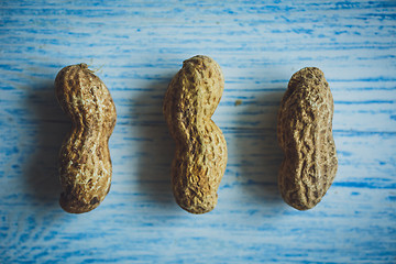 Image showing Fresh peanuts in shell on blue desk