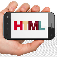 Image showing Database concept: Hand Holding Smartphone with Html on  display