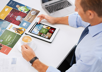 Image showing businessman with tablet pc and coffee in office