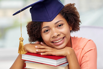 Image showing happy african bachelor girl with books at home